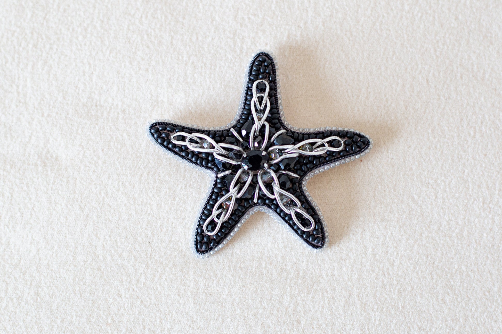 a black and white starfish on a white surface