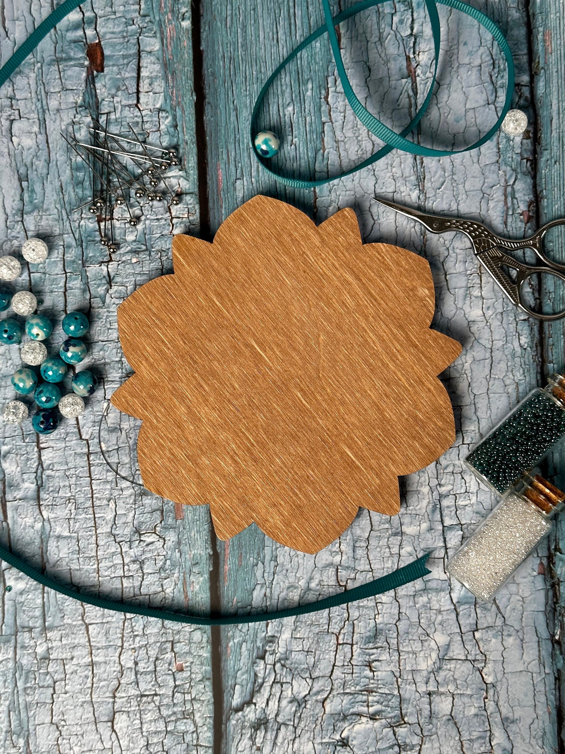 a wooden frame surrounded by scissors and beads