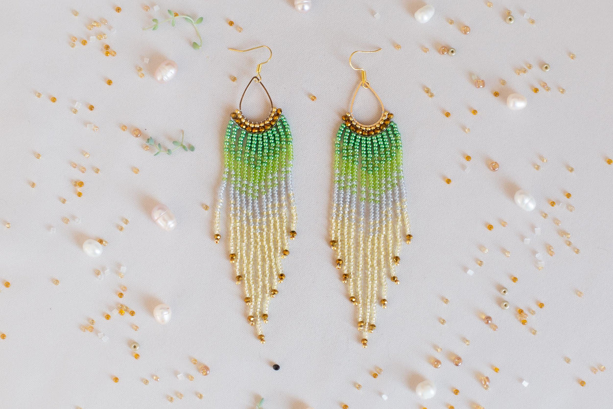 a pair of green and yellow beaded earrings