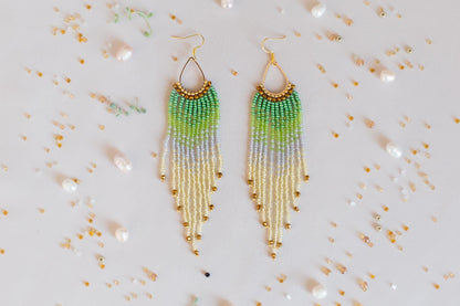 a pair of green and yellow beaded earrings