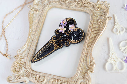 a picture frame with a black and gold brooch