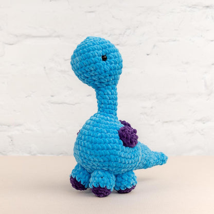 a crocheted blue toy sitting on top of a table