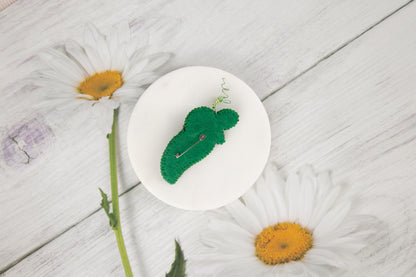 a white plate topped with a green piece of broccoli