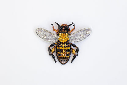 a yellow and black insect sitting on top of a white surface