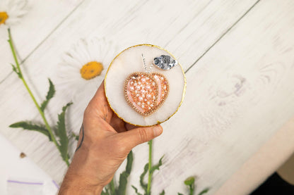 a person holding a heart shaped object in their hand