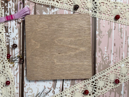 a book on a table with a string of thread