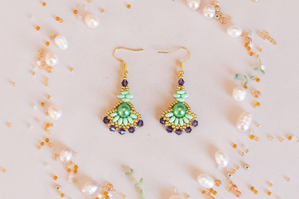 a pair of earrings sitting on top of a table