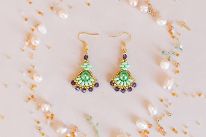 a pair of earrings sitting on top of a table
