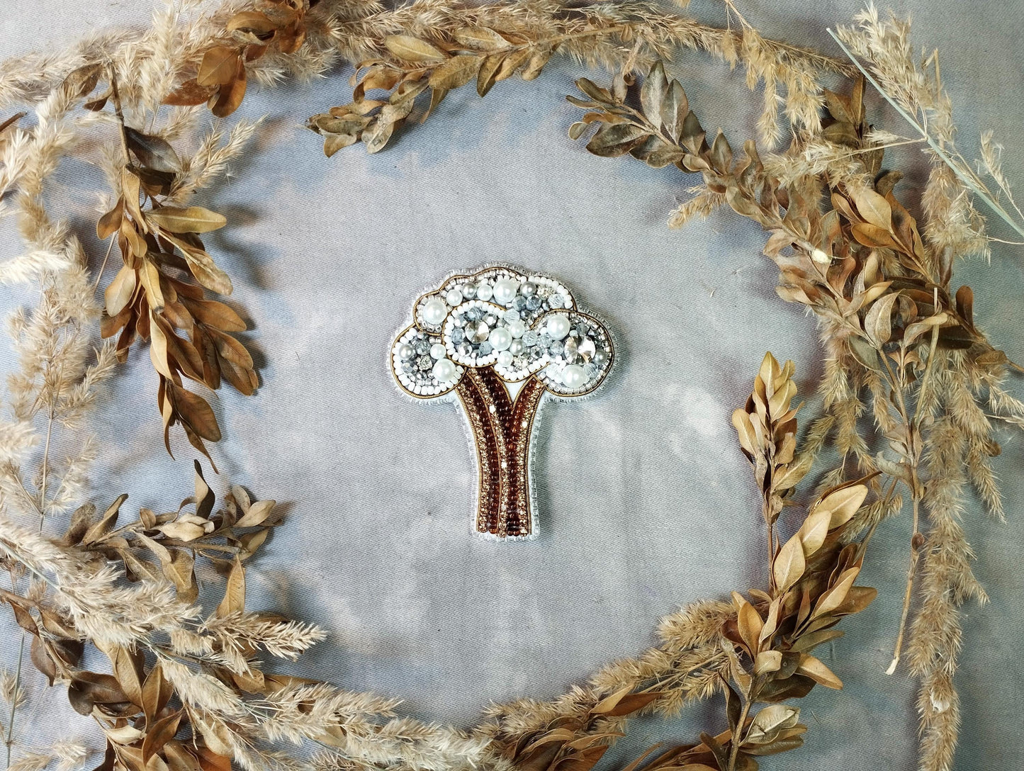 a brooch with a tree in the middle of it