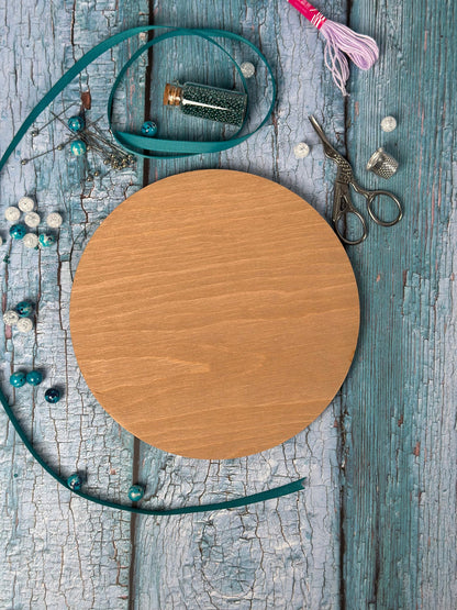 a round wooden board surrounded by other items