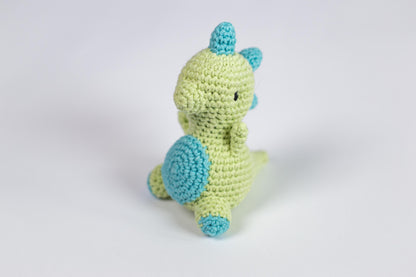 a crocheted green and blue stuffed animal