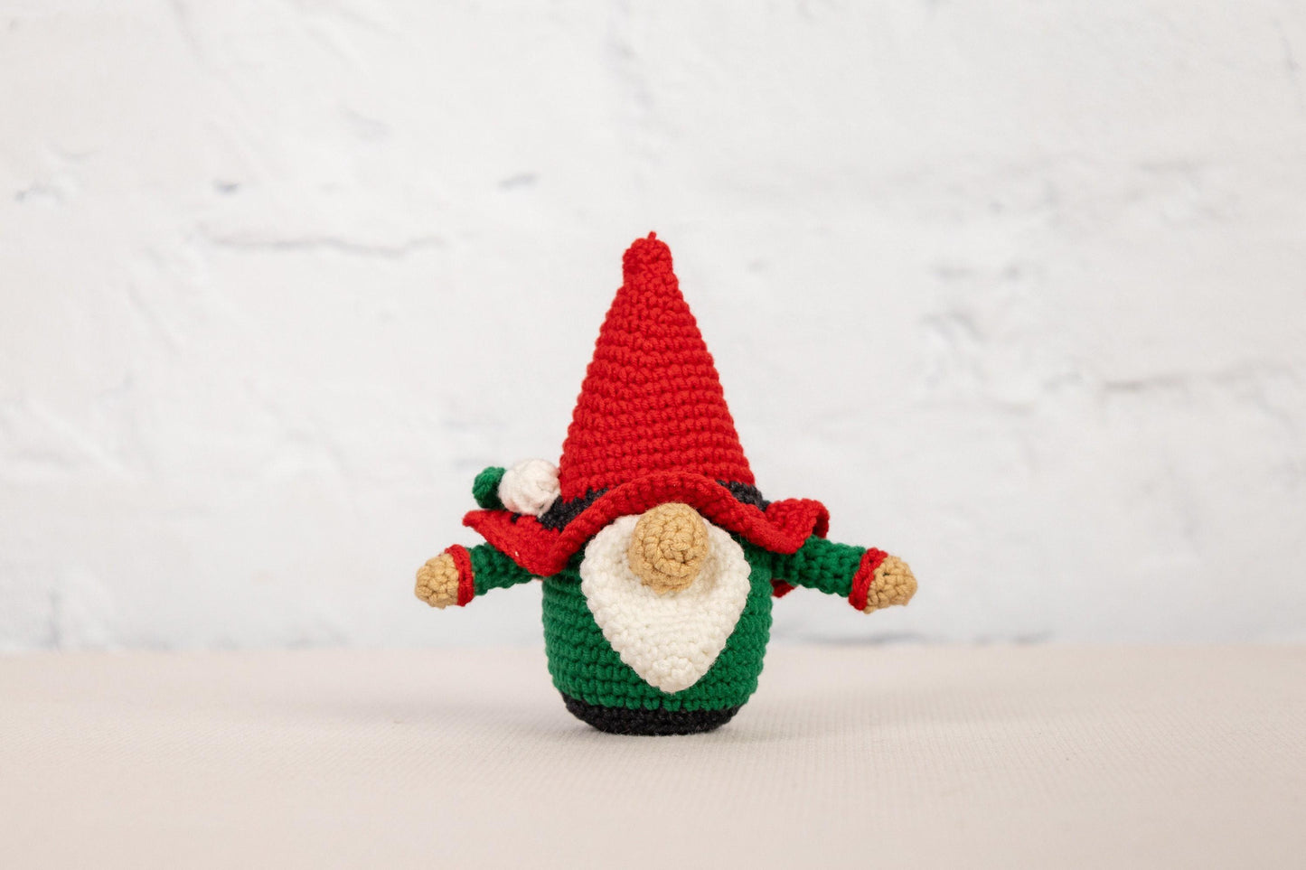 a small crocheted christmas decoration with a santa clause on it