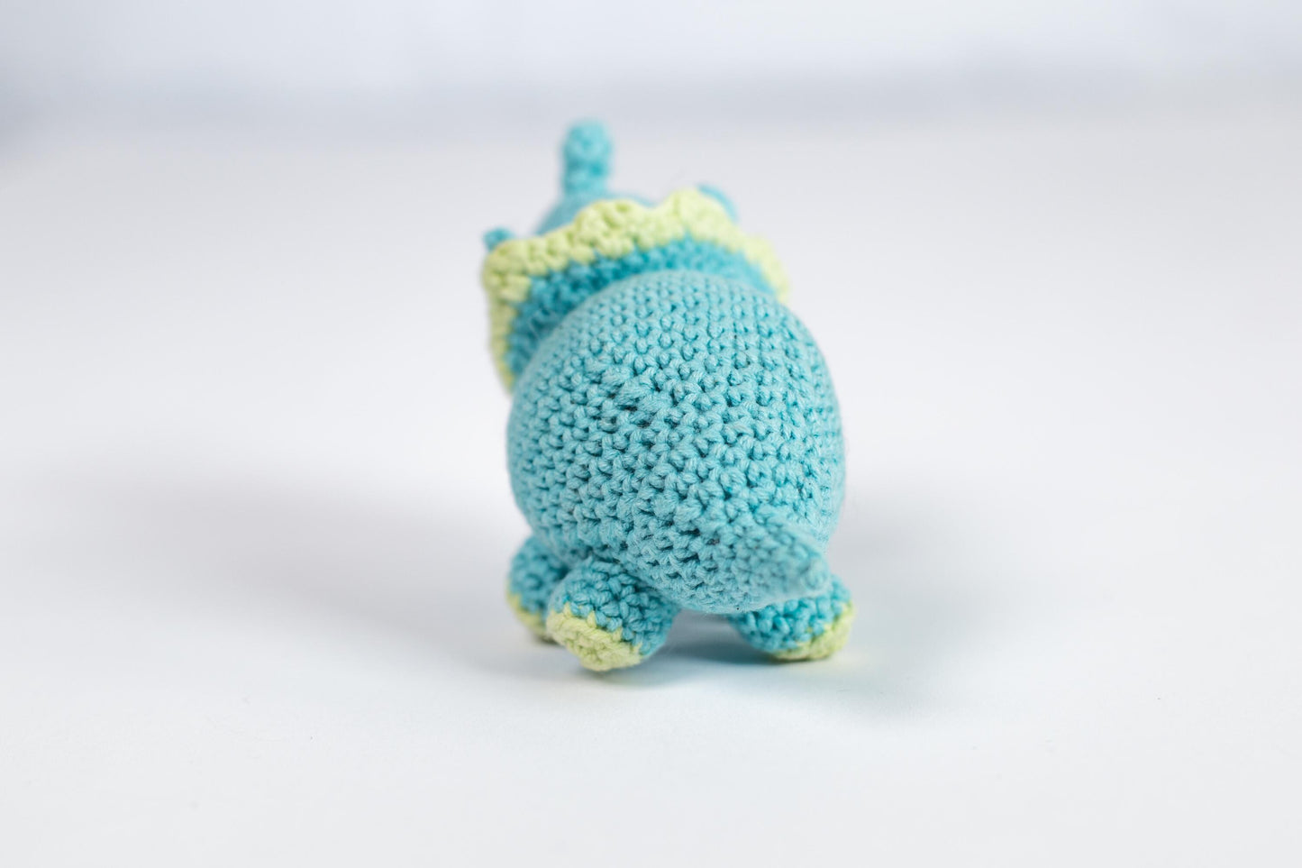 a small crocheted blue and yellow stuffed animal