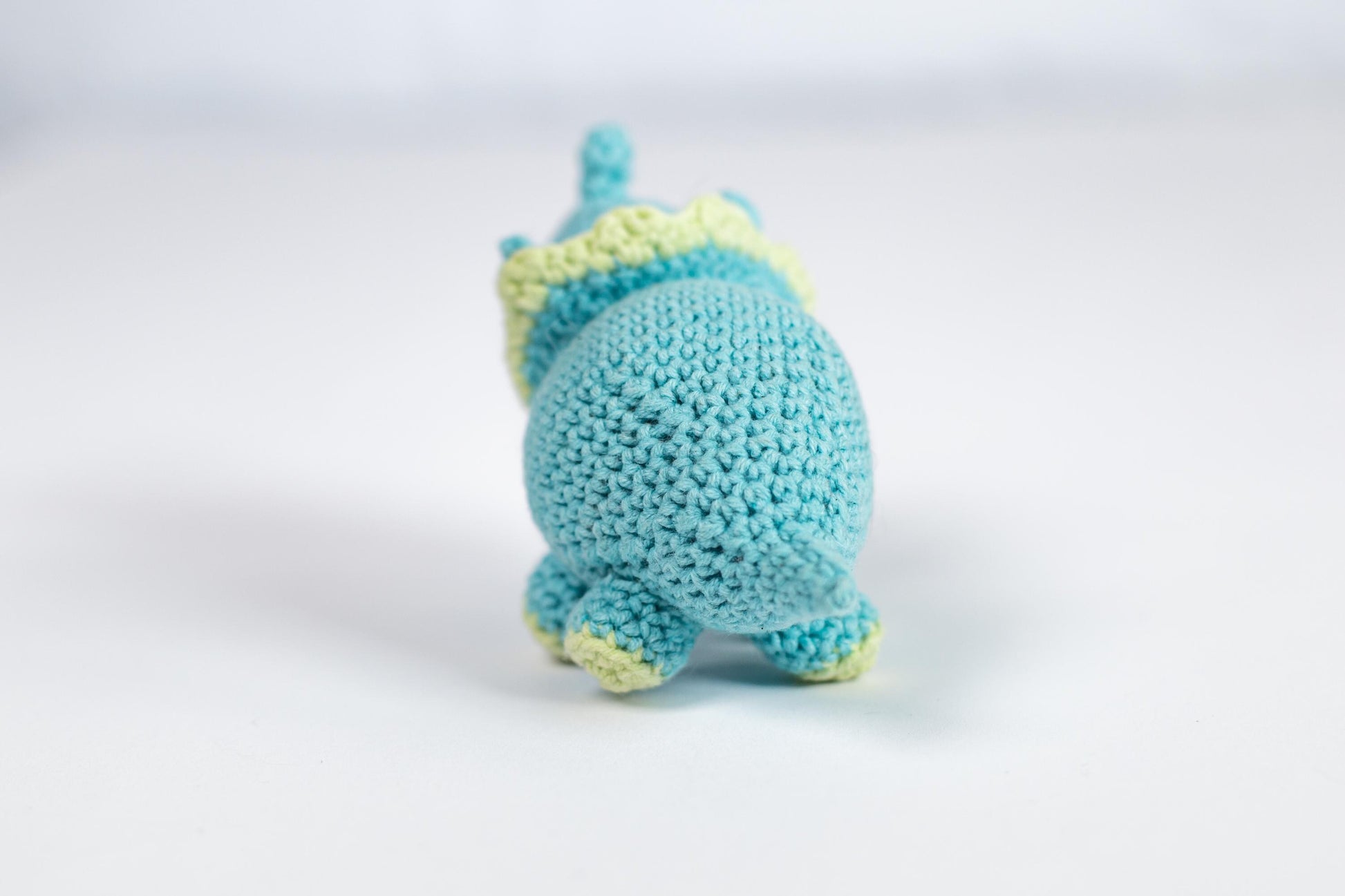 a small crocheted blue and yellow stuffed animal