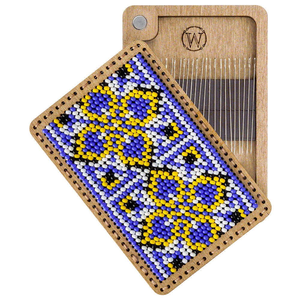 a piece of wood with a beaded design on it