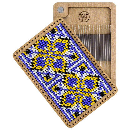 a piece of wood with a beaded design on it