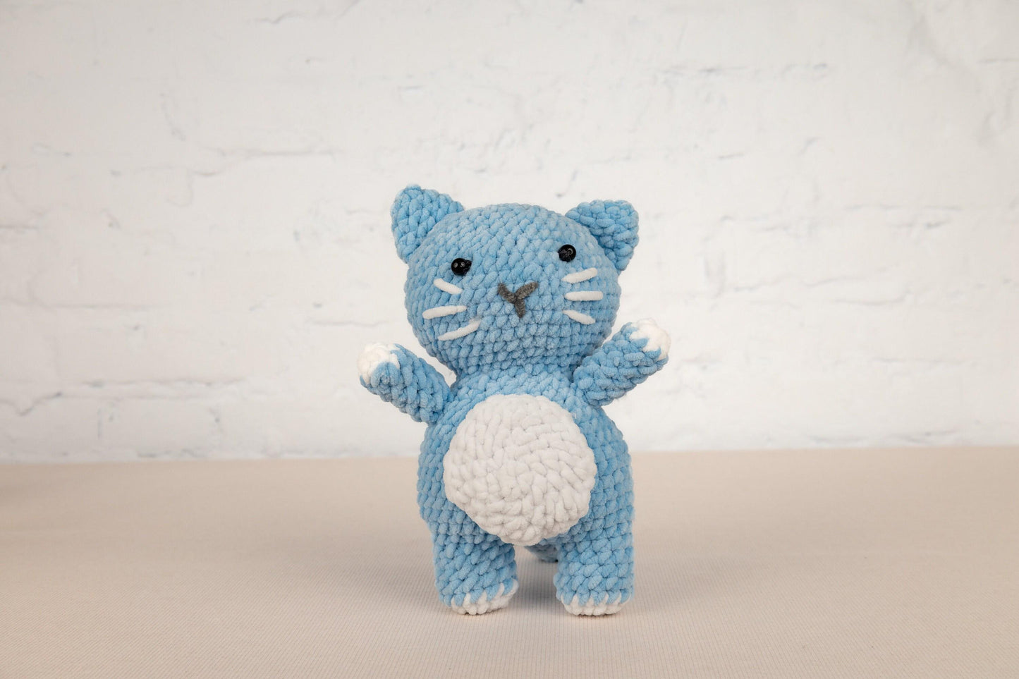 a crocheted blue and white kitty cat