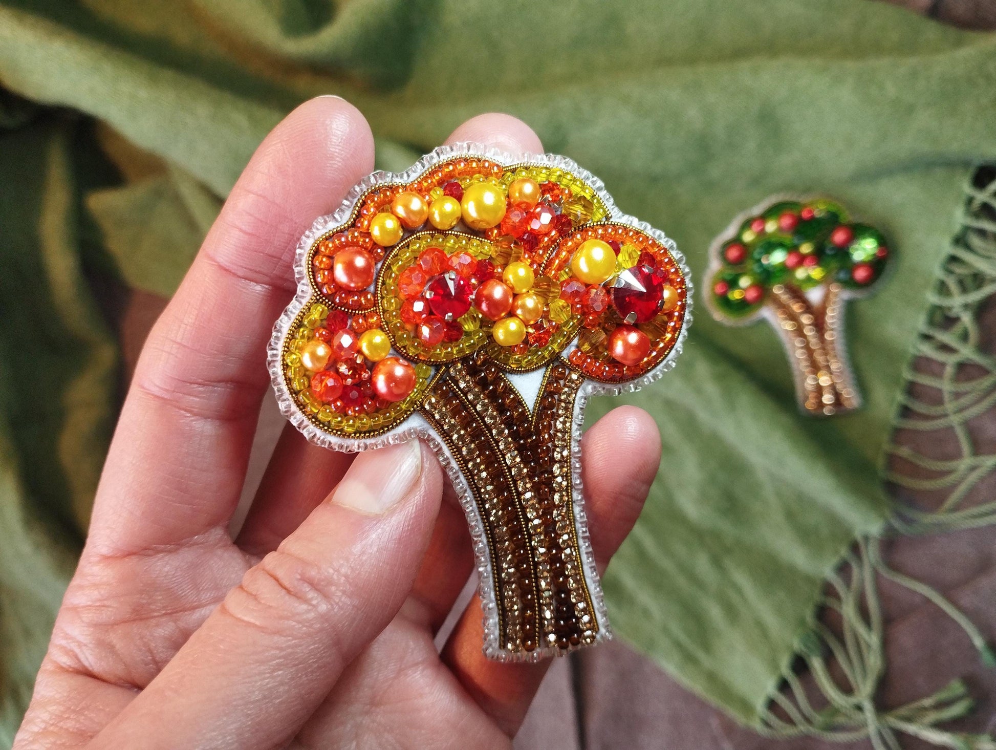 a person holding a brooch in their hand