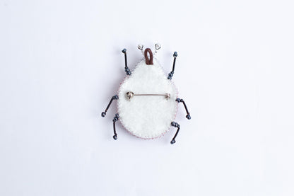 a white clock with a bug on it&#39;s face