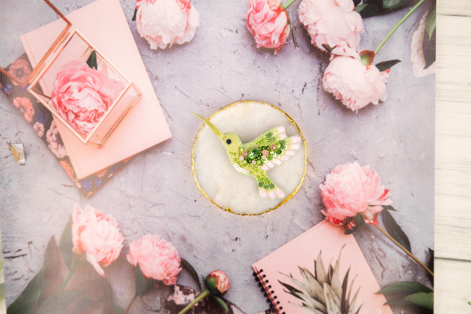 a table topped with pink flowers and a bird decoration