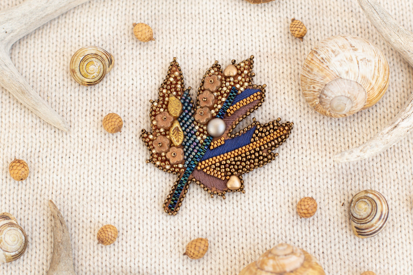 a picture of a brooch with a leaf on it