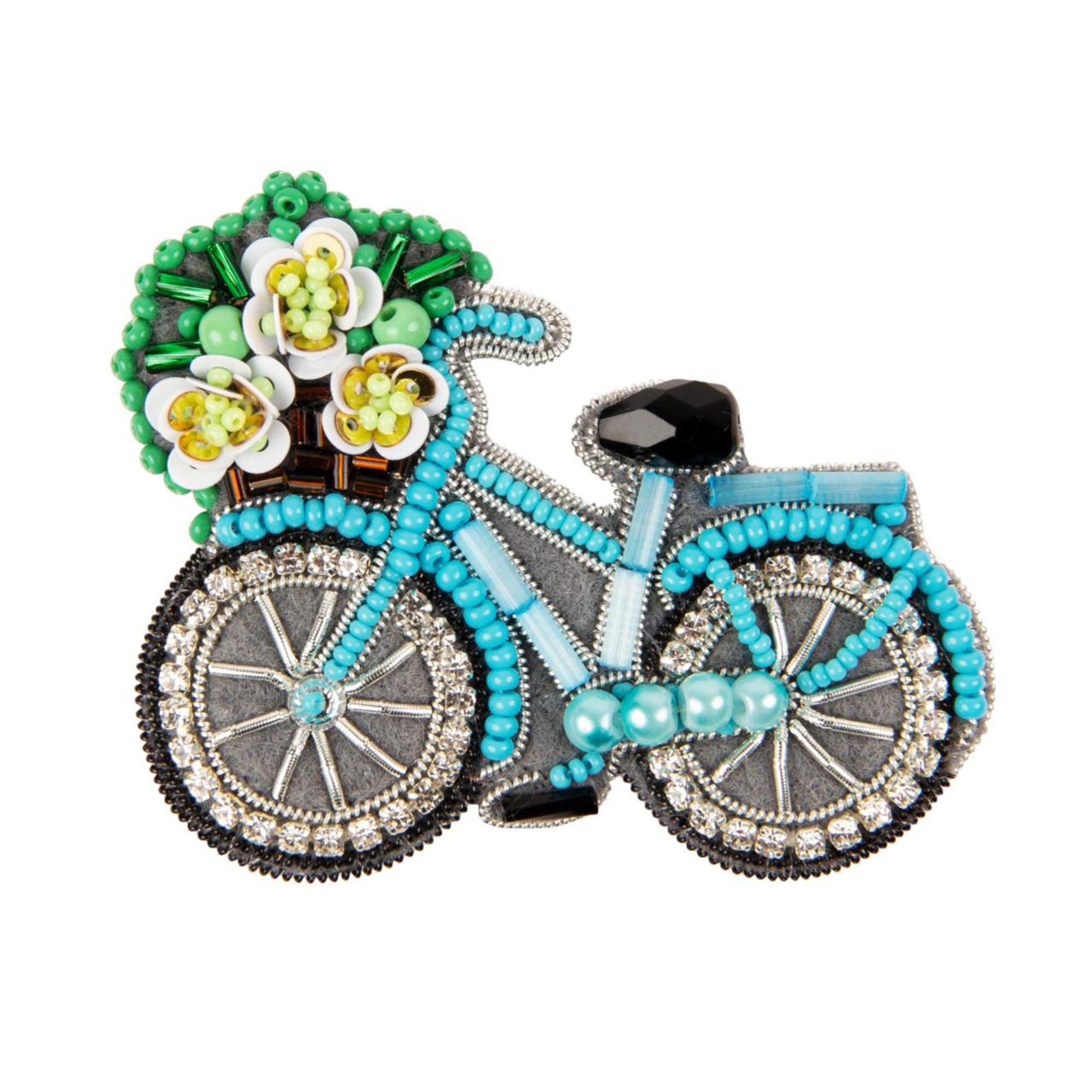 a brooch with a blue bicycle and flowers on it