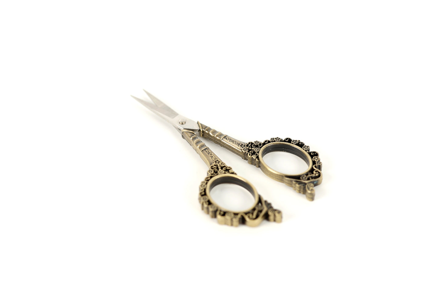 A pair of ornate scissors with decorative handles and blades is shown against a white background.