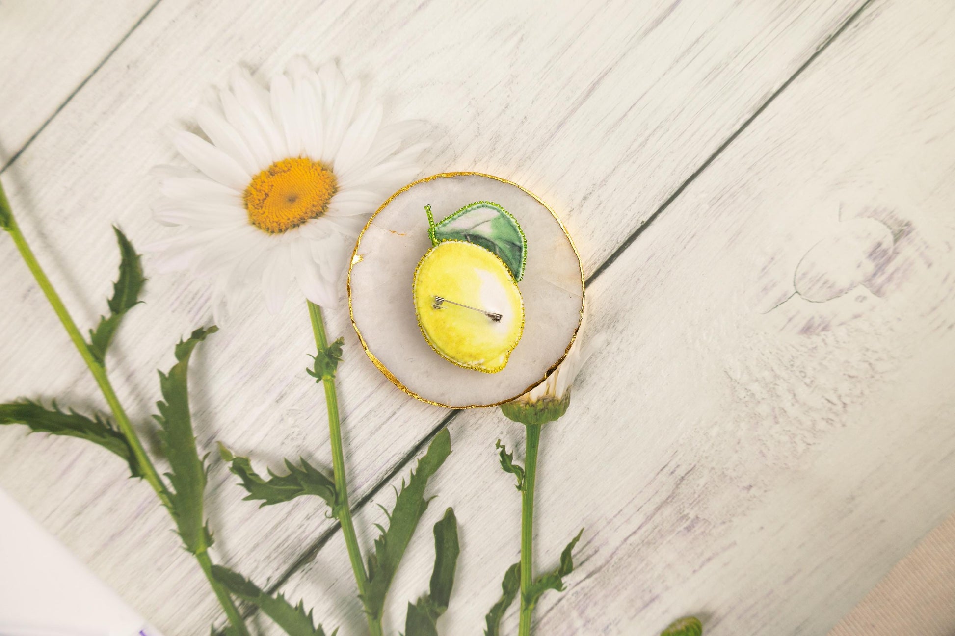 a plate with a lemon and a flower on it