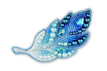 a blue and white brooch with pearls on it