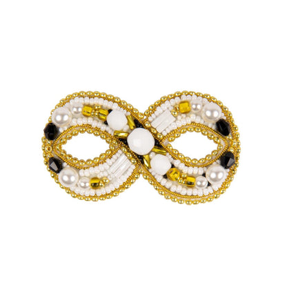 a gold and white beaded brooch