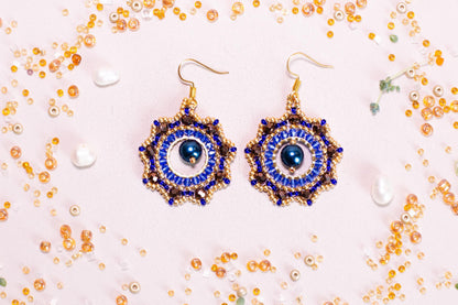 a pair of blue and gold beaded earrings