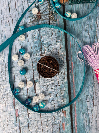 a piece of wood that has some beads on it