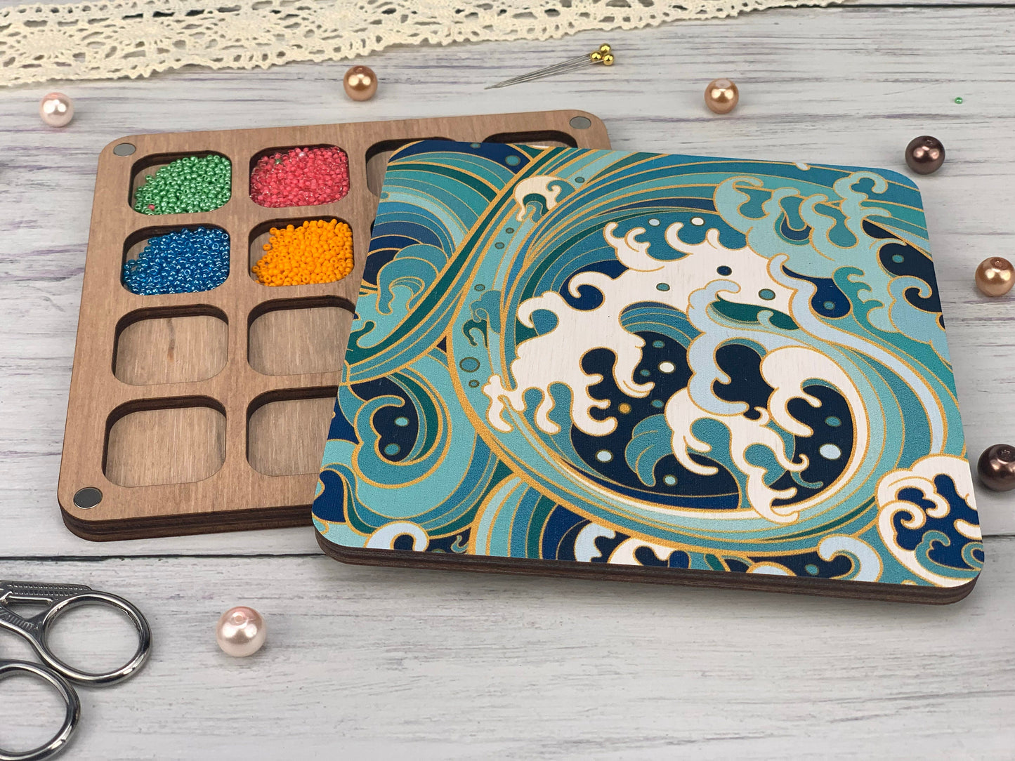 a box of beads next to a pair of scissors