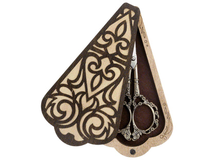 a pair of scissors sitting inside of a wooden holder