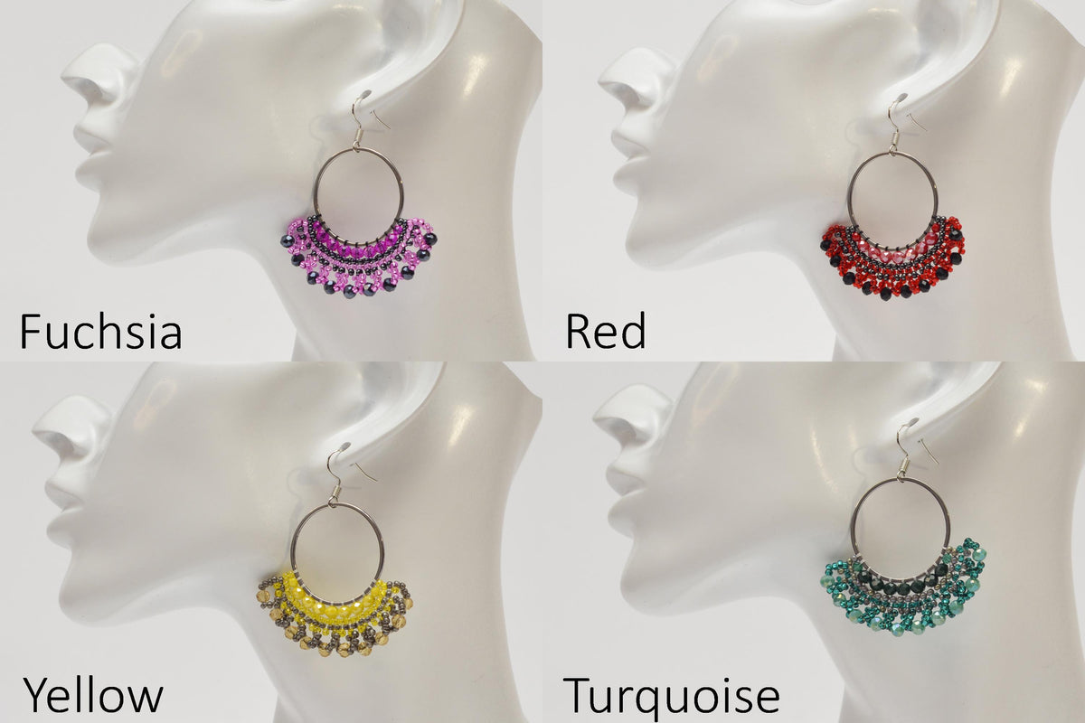 four different earrings, each with a unique color and design, arranged on a white mannequin head.