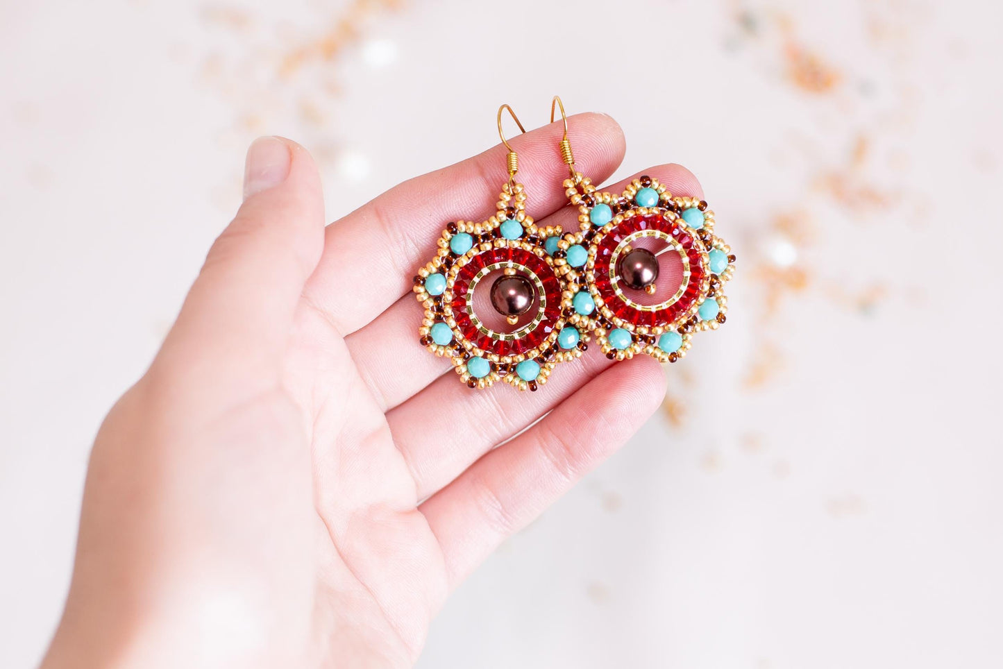 a person holding a pair of earrings in their hand