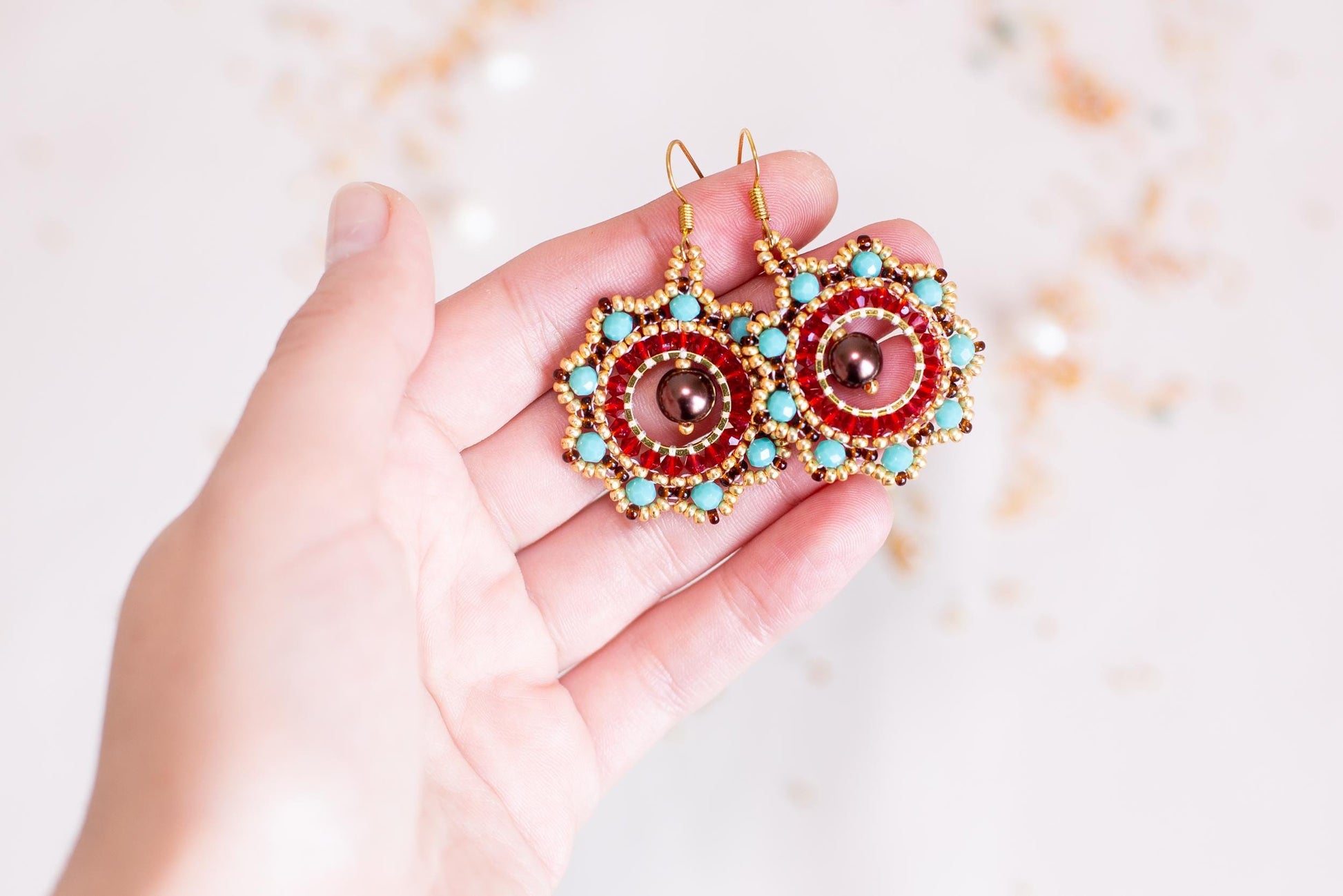 a person holding a pair of earrings in their hand