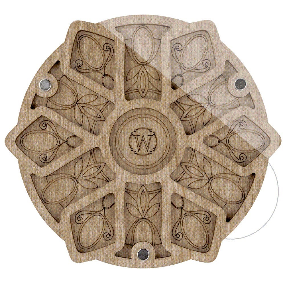 a carved wooden coaster with a monogrammed design