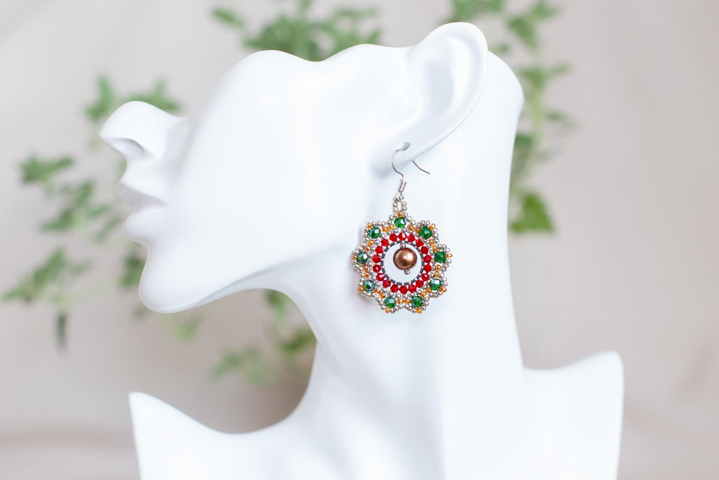a close up of a pair of earrings on a mannequin head