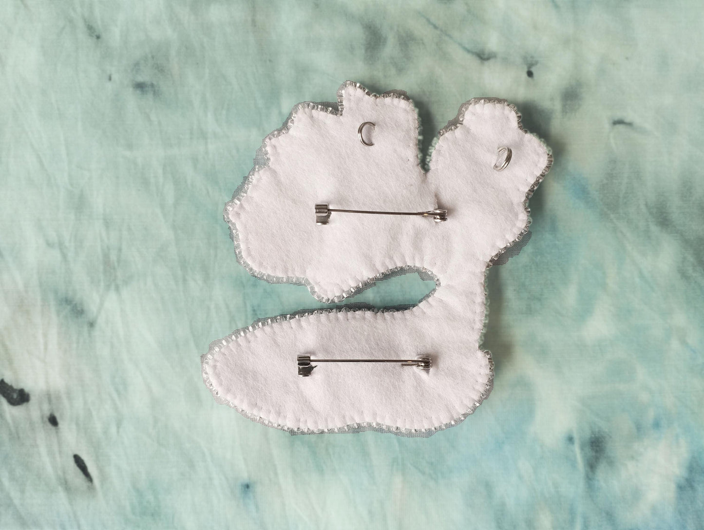 a pair of white hair clips sitting on top of a table