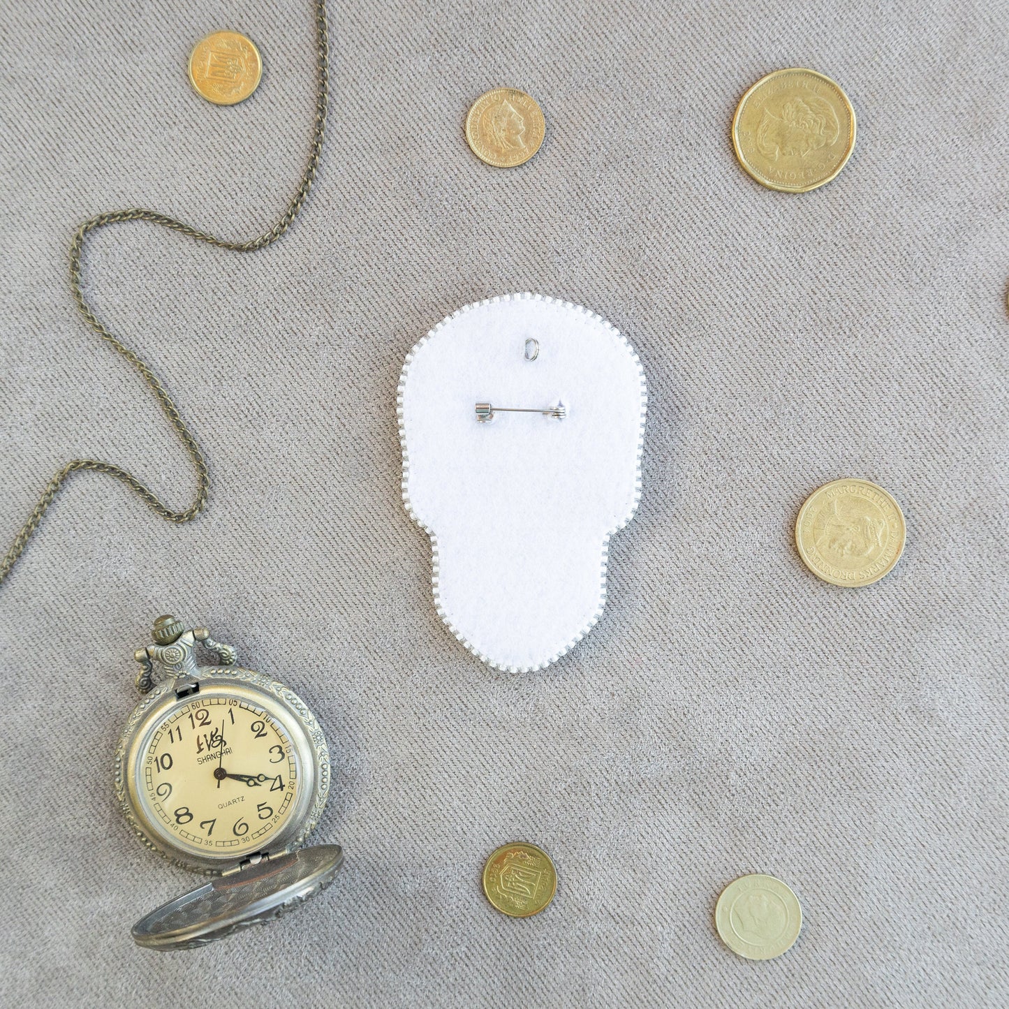 a clock and some coins on a table
