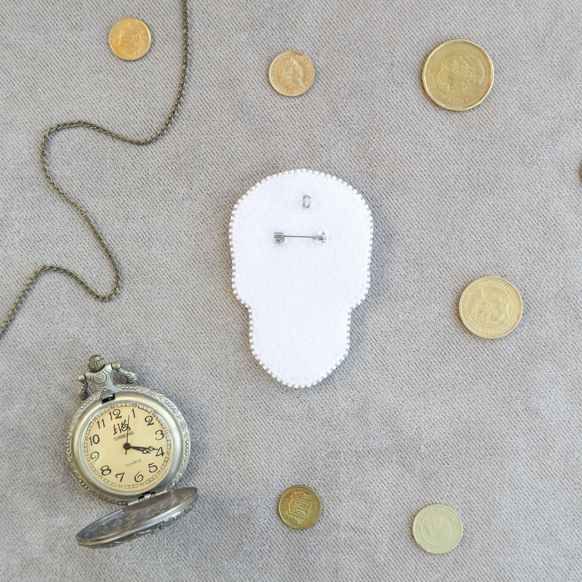 a clock and some coins on a table