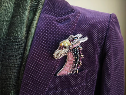 A purple velvet jacket with a decorative dragon brooch pinned to the lapel.