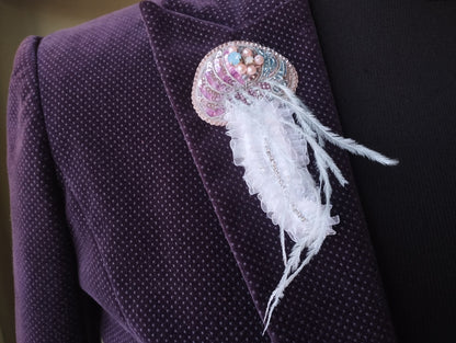 A close-up view of a purple jacket with a decorative brooch or pin attached to the lapel.