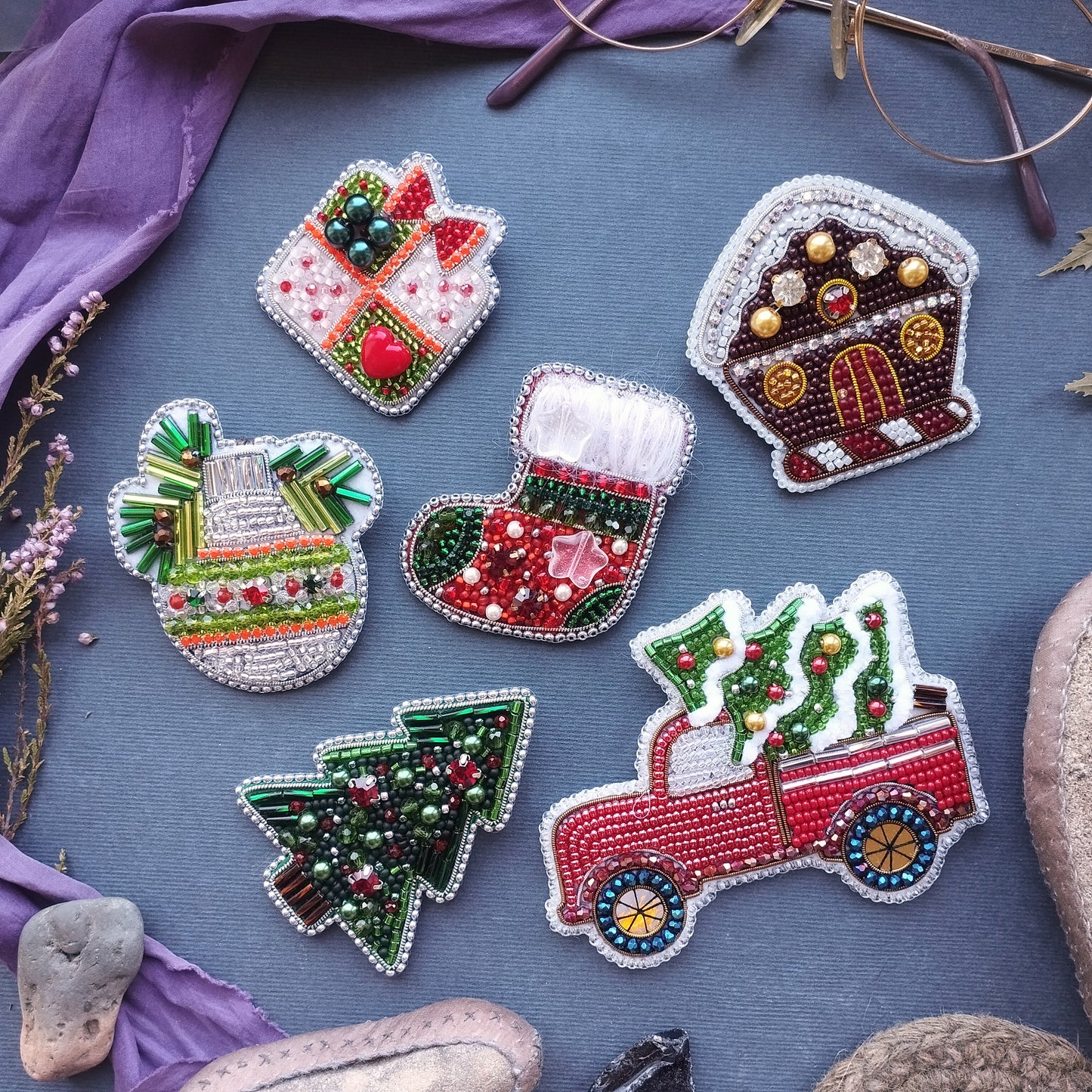 a collection of six decorative items, including a Christmas tree, a gingerbread house, a gift box, a stocking, a Christmas tree in a truck, and a snowman, all intricately crafted with beads and other embellishments.
