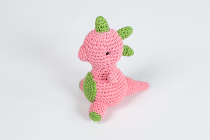 a crocheted pink and green stuffed animal