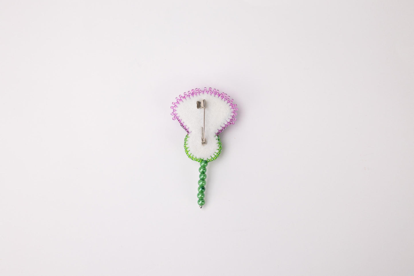 a white clock with a green cord attached to it