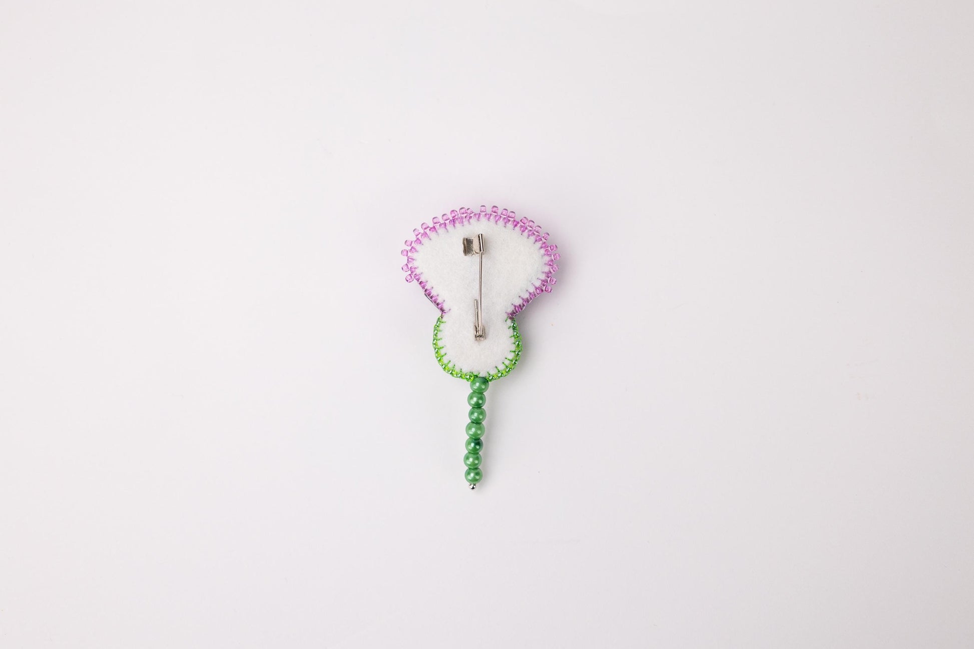 a white clock with a green cord attached to it