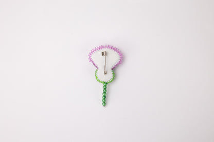 a white clock with a green cord attached to it