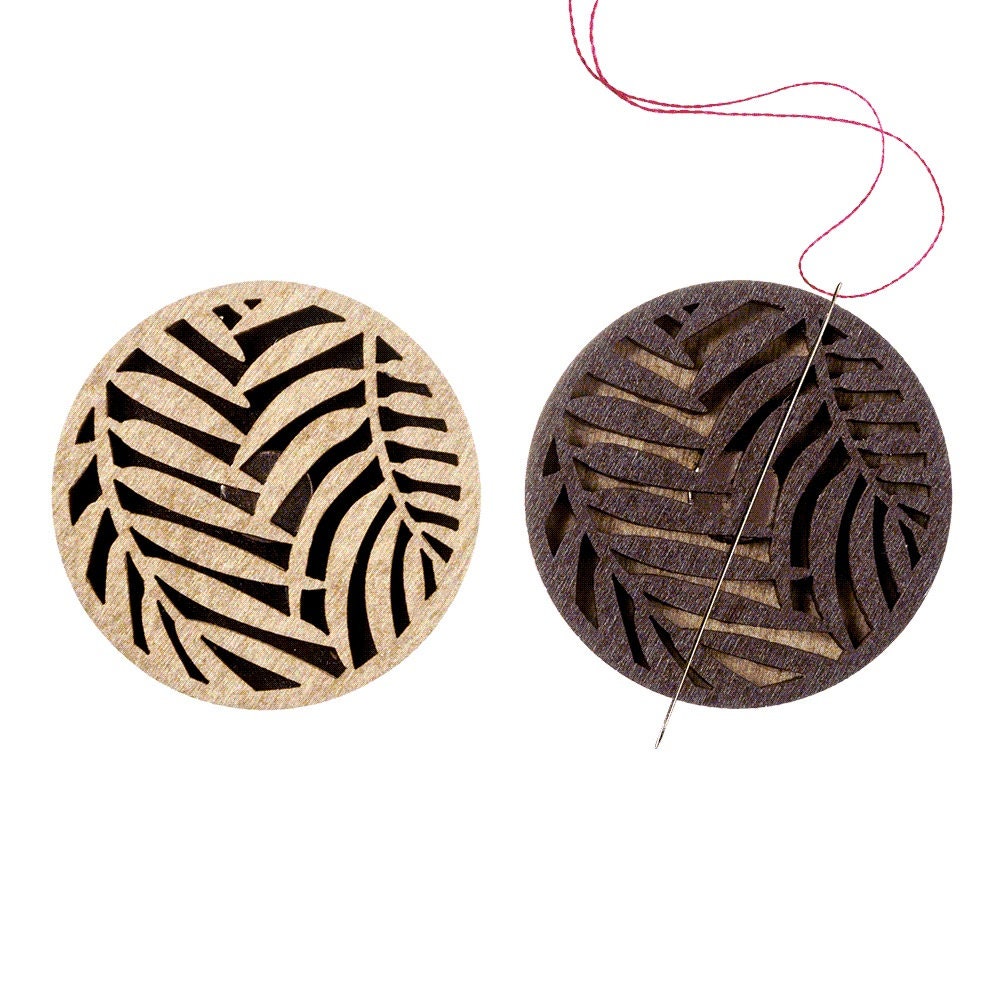 a pair of wooden coasters with a design of a leaf